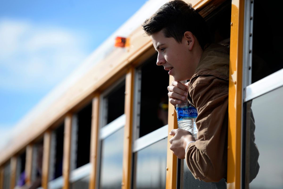 Haylen Orgunez, 14, hangs out the window of one of the new compressed natural gas buses as he poses for a group photo at Douglas County High School in Castle Rock, Colorado on November 16, 2016.  (Photo by Seth McConnell/The Denver Post)