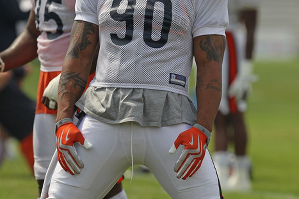 BOURBONNAIS, IL - AUGUST 06: Julius Peppers #90 (North Carolina) of the Chicago Bears stretches during a summer training camp practice at Olivet Nazarene University on August 6, 2011 in Bourbonnais, Illinois. (Photo by Jonathan Daniel/Getty Images)