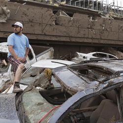 Antonio Flores of Moore, Okla. searches for his car after a tornado damaged the Moore Medical Center and the vehicles in the parking lot in Moore, Okla. on Monday, May 20, 2013.
