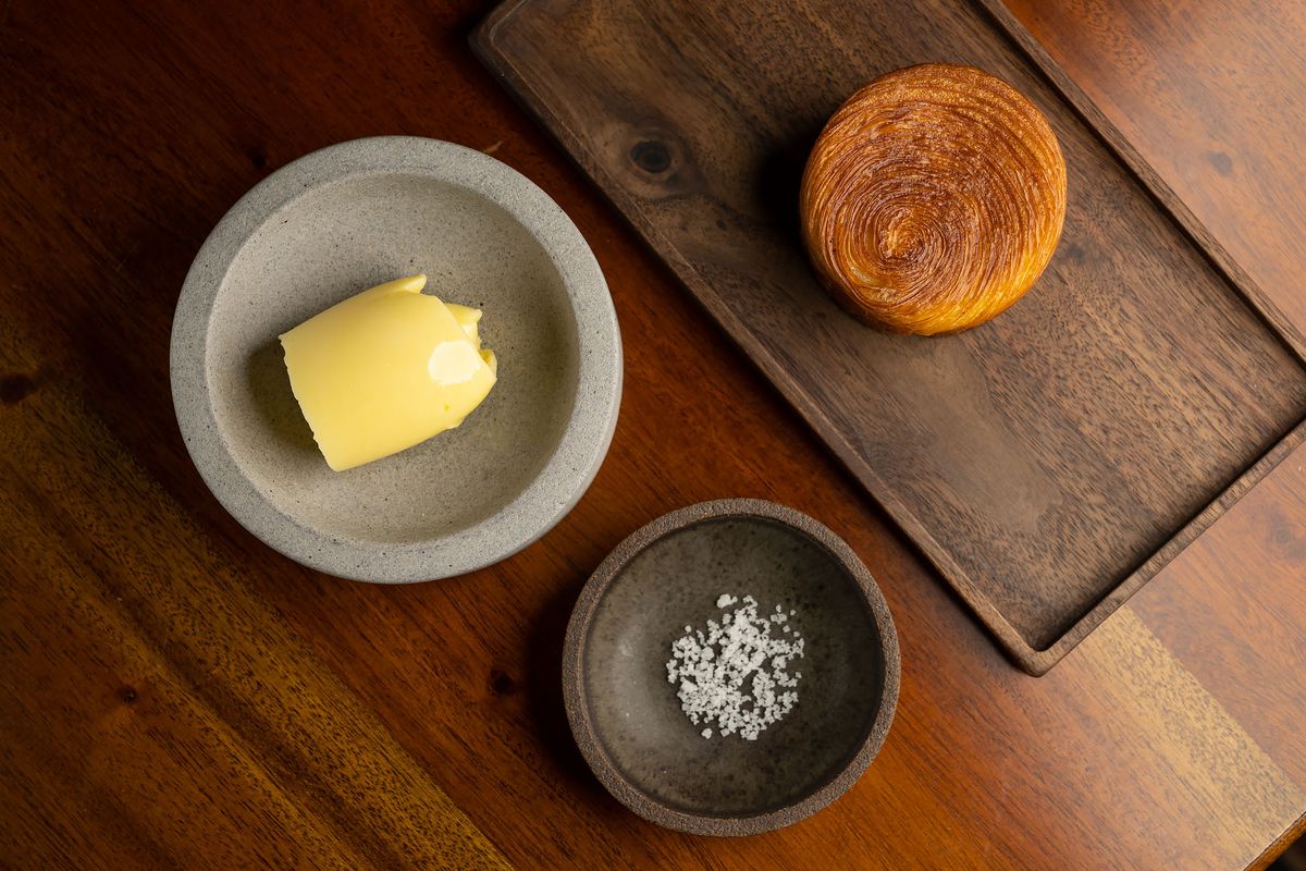 Brioche with butter and fleur de sel laid out in three plates.
