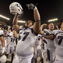 Utah State guard Funaki Asisi (76), Havea Lasike (57) and Al Lapuaho (77) along with the rest of the Utah State football team celebrate their 35-31 win of Hawaii with their fans at the end of a NCAA college football game Saturday, Nov. 5, 2011, in Honolulu. (AP Photo/Eugene Tanner) Lapuaho signed an NFL free agent deal with the St. Louis Rams.