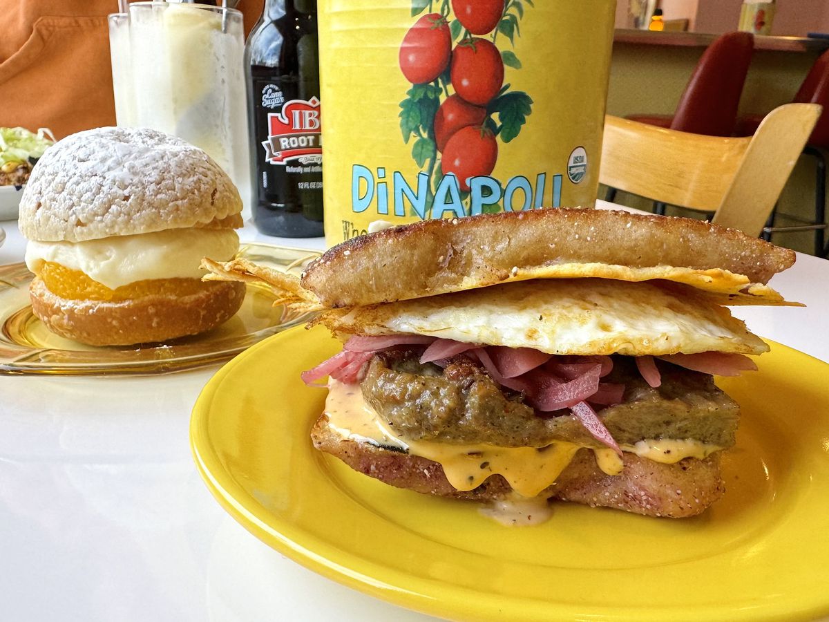 Funky Flame’s OG breakfast sandwich wiht an orange sweet cream bun