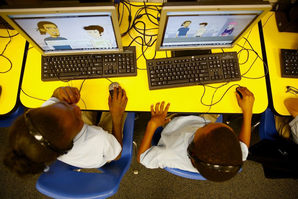 Students at University Prep, a Denver elementary charter school, work on a computer-based assignment .