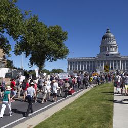 Protesters march toward the state Capitol during a rally against the separation of immigrant children from their parents in Salt Lake City on Saturday, June 30, 2018.