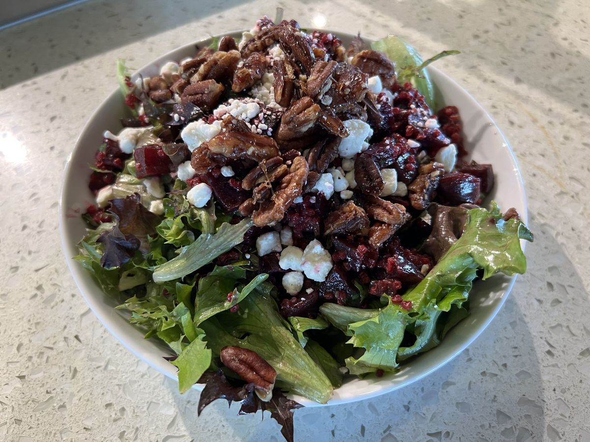 A salad topped with nuts..