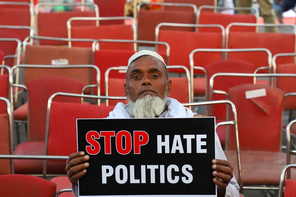 An elderly man holds a placard saying “Stop Hate Politics” during a protest against the Citizenship Amendment Bill in New Delhi, India.