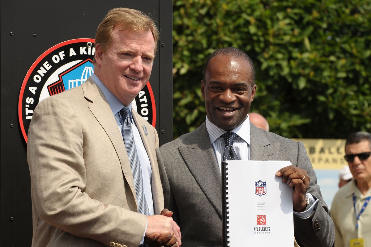 Commissioner of the National Football League, Roger Goodell and Director of the National Football League Players’ Association, DeMaurice Smith pose with the new Collective Bargaining Agreement on the front steps of the Pro Football Hall of Fame on August 5, 2011 in Canton, Ohio.
