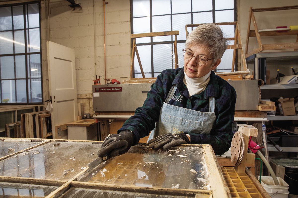 Alison Hardy removes old putty and paint from an antique window in her workshop. “A lot of times, people will look at old windows and say, ‘That’s too rotted; you can’t fix that,’ ” she says. “But most of the time, it’s just the paint that’s bad—once you get that off, you see how beautifully built they are.”