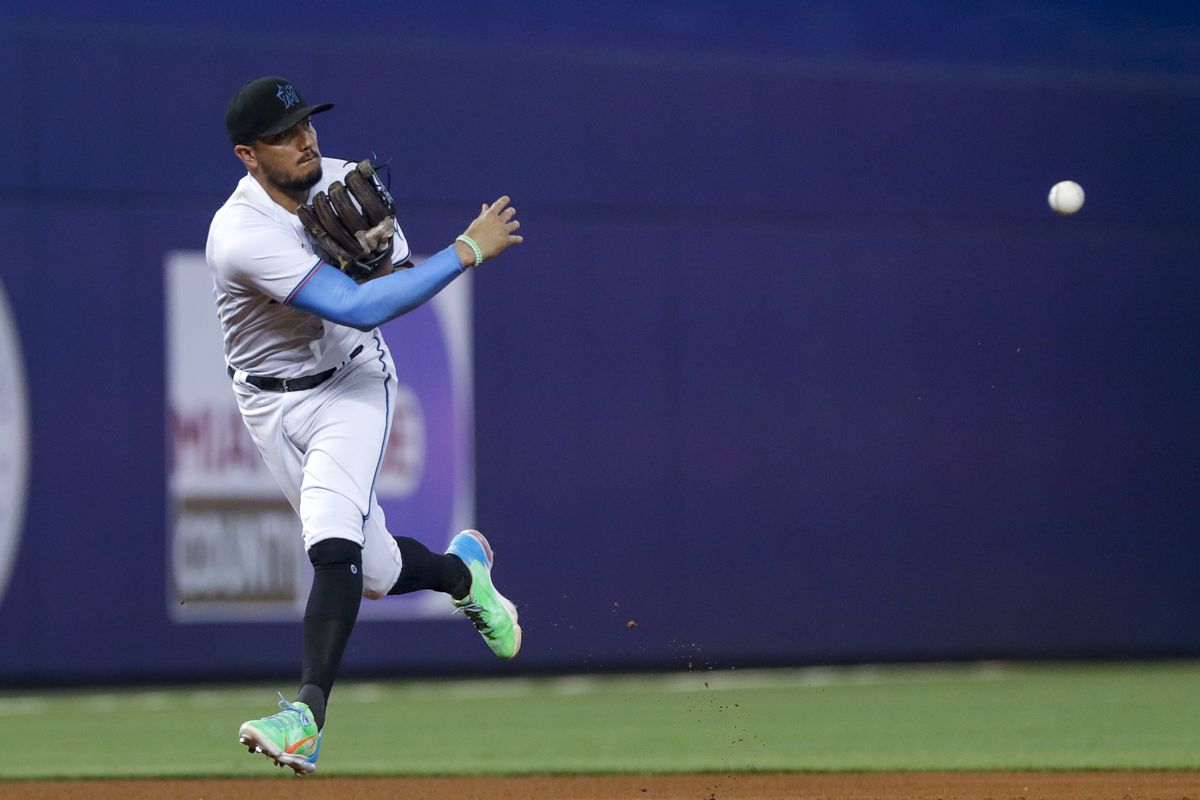 Miami Marlins shortstop Miguel Rojas (19) throws to second base and takes out Cincinnati Reds first baseman Joey Votto (not pictured) during the seventh inning at loanDepot Park.&nbsp;