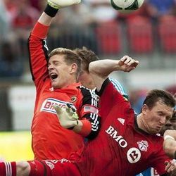 Toronto FC's Steven Caldwell, right, collides with Philadelphia Union goalie Chris Konopka during the first half of an MLS soccer game action Saturday June 1, 2013, in Toronto.