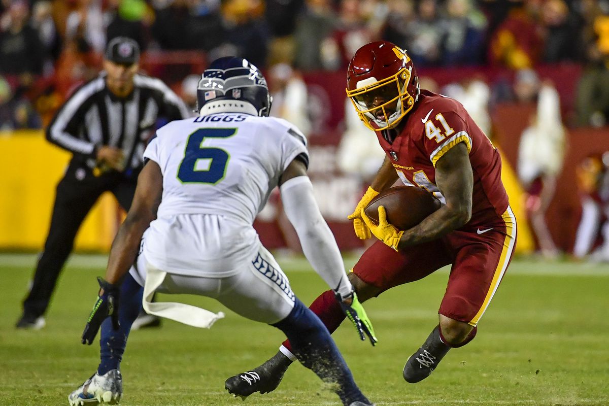 Washington Football Team running back J.D. McKissic (41) carries the ball as Seattle Seahawks safety Quandre Diggs (6) defends during the second half at FedExField.