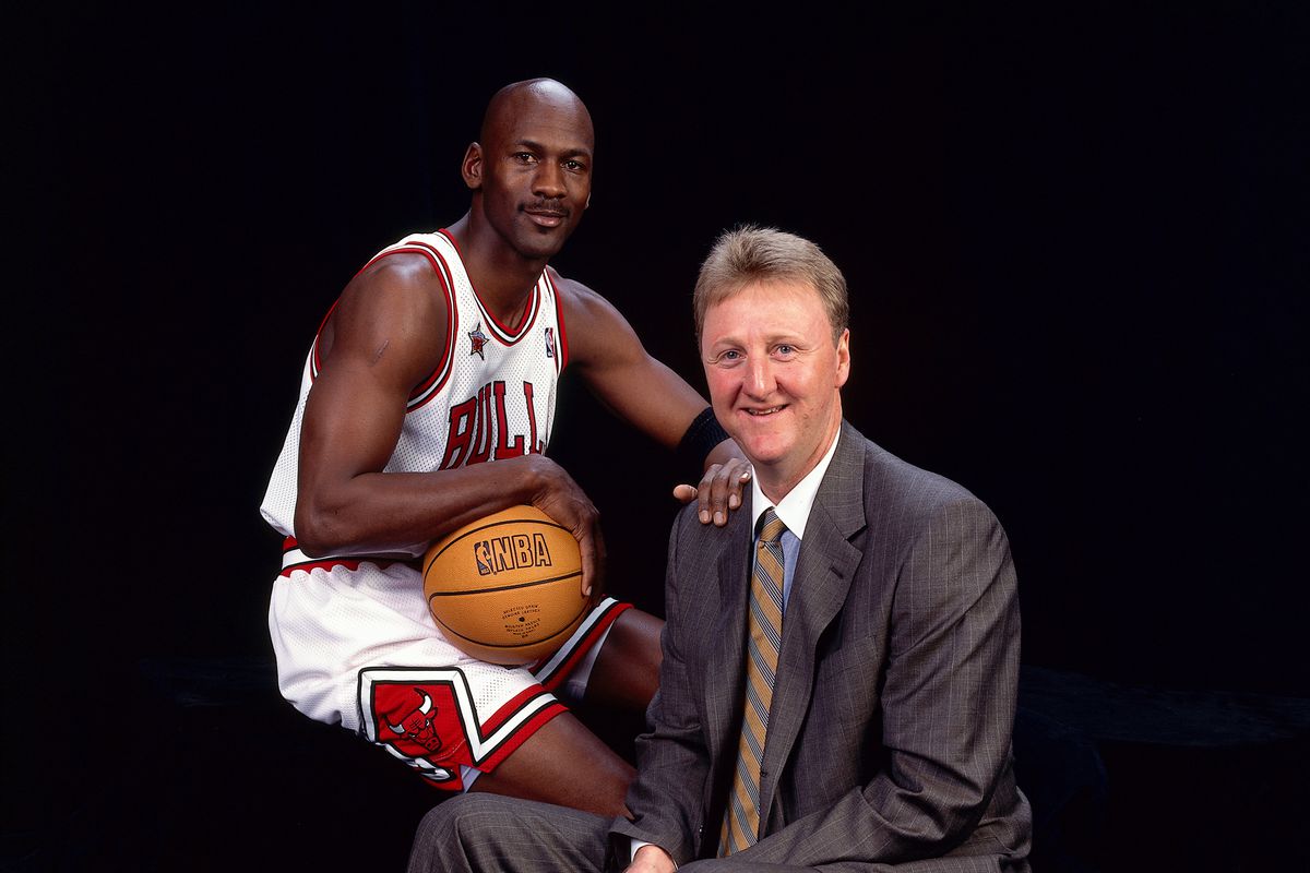 Larry Bird and Michael Jordan pose for a portrait