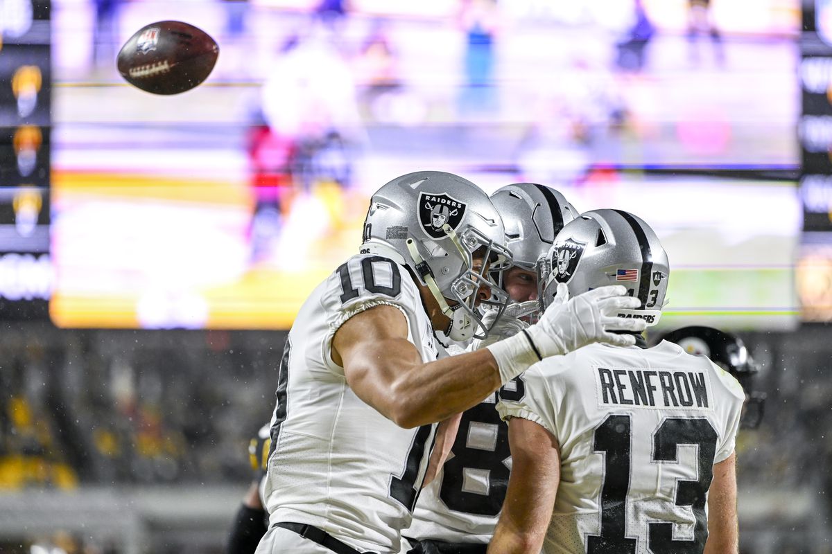 Hunter Renfrow #13 of the Las Vegas Raiders celebrates touchdown with Mack Hollins #10 of the Las Vegas Raiders in the first quarter at Acrisure Stadium on December 24, 2022 in Pittsburgh, Pennsylvania.