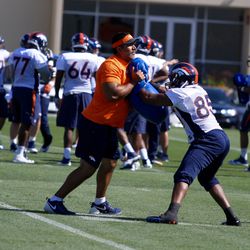 Broncos TE Virgil Green pushes hard against the rush during drills
