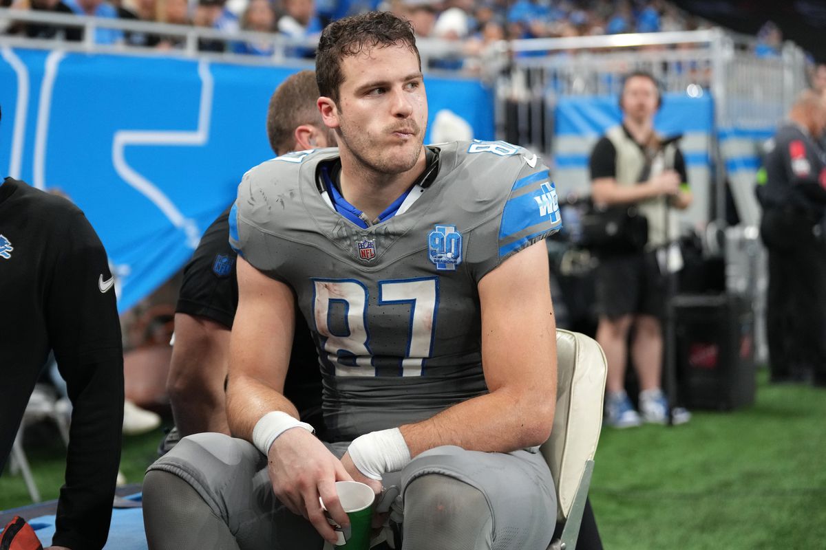 Sam LaPorta of the Detroit Lions is taken off the field during the first half in the game against the Minnesota Vikings at Ford Field on January 07, 2024 in Detroit, Michigan.