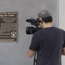 A plaque is dedicated by the Salt Lake City Police Department at the Gallivan Center in memory of detective Green B. Hamby, who was killed 92 years ago while tracking down a burglary suspect, Monday, April 29, 2013, in Salt Lake City.