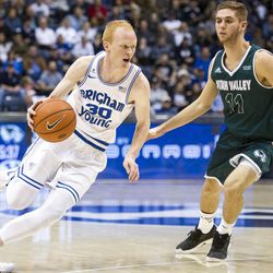 Brigham Young guard TJ Haws (30) drives the lane against Utah Valley guard Conner Toolson (11) during an NCAA college basketball game in Provo on Saturday, Nov. 26, 2016. Utah Valley was 18 of 37 from beyond the arc en route to a 114-101 ousting of Brigham Young.