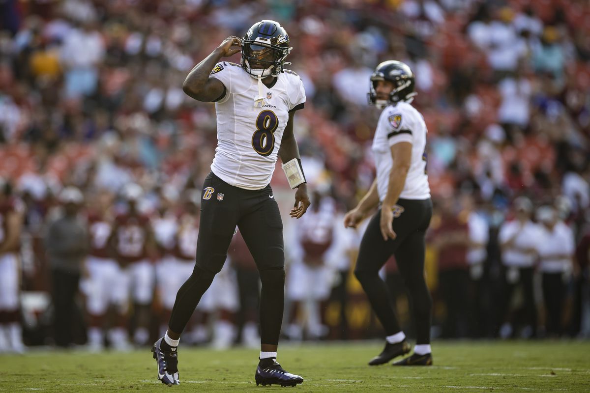 : Lamar Jackson #8 of the Baltimore Ravens looks on against the Washington Football Team during the first half of the preseason game at FedExField on August 28, 2021 in Landover, Maryland.