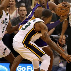 Los Angeles Lakers' Kobe Bryant keeps the ball from Utah's Chris Johnson during the game at the Vivint Smart Home Arena in Salt Lake City on Monday, March 28,  2016.  