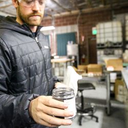 The final product, Chris Vidmere shows a jar of pure carbon at Solid Carbon Products in Provo, Monday, Sept. 25, 2017.