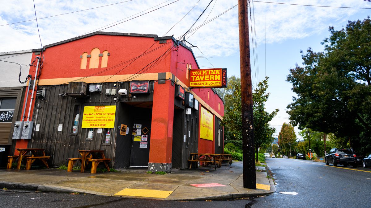 A red building in Southeast Portland sports a sign that says “Reel M Inn”