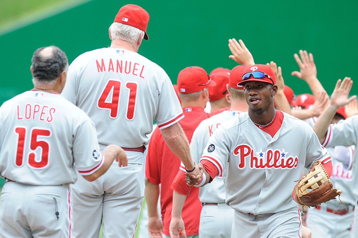 What a strange picture, and raises many questions: Is Charlie Manuel 7'5"?  Is Domonic Brown running through a ditch?  Davey Lopes limp-wristin' it?  (Photo by Greg Fiume/Getty Images)