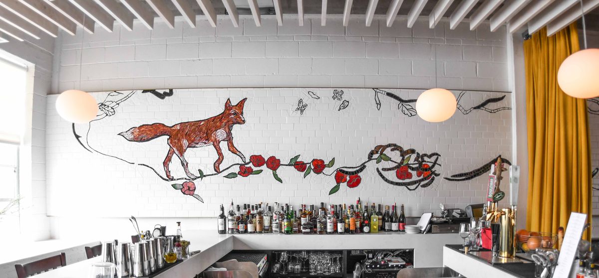 A tile mural depicting a fox and poppies by Laura Rendlen at Novel