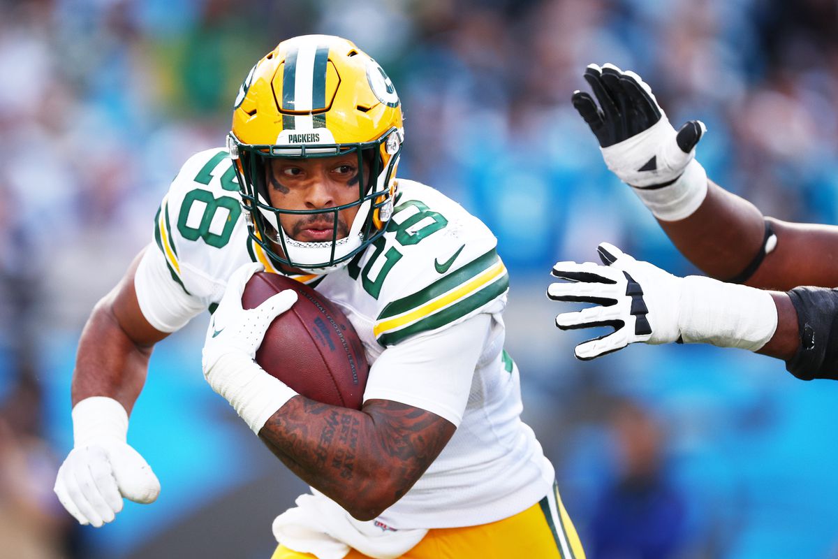 AJ Dillon of the Green Bay Packers carries the ball during the fourth quarter against the Carolina Panthers at Bank of America Stadium on December 24, 2023 in Charlotte, North Carolina.