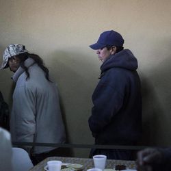 In this April 18, 2013, photo, Migrants and recent deportees from the U.S. wait in line to wash their hands during mealtime at the Padre Chava migrant shelter in the northern border city of Tijuana. Deportations topped 400,000 in fiscal 2012, more than double from seven years earlier, sending Mexicans to border cities like Tijuana where they often struggle to find work. 