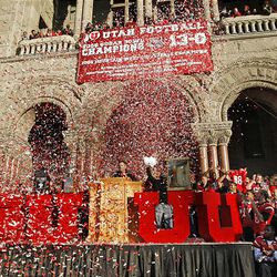 Utah coach Kyle Whittingham is showered with confetti as the University of Utah football players, coaches, band, cheerleaders and dignitaries are honored with a parade in downtown Salt Lake and a pep rally at the Salt Lake City-County Building Friday. 