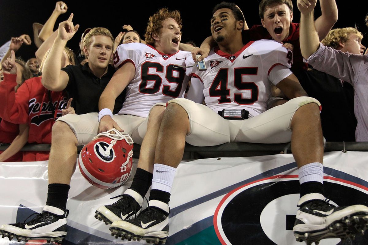 JACKSONVILLE, FL - OCTOBER 29:  Georgia Bulldog players celebrate with fans following a win over the Florida Gators 24-20 at EverBank Field on October 29, 2011 in Jacksonville, Florida.  (Photo by Sam Greenwood/Getty Images)