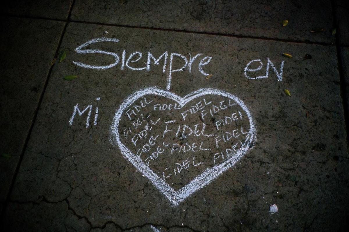 A heart and the text that reads in Spanish "Always in my heart Fidel" are outlined in chalk on a sidewalk, during a vigil at the university where the late Cuban leader Fidel Castro studied law as a young man in Havana, Cuba, Saturday, Nov. 26, 2016. Castr
