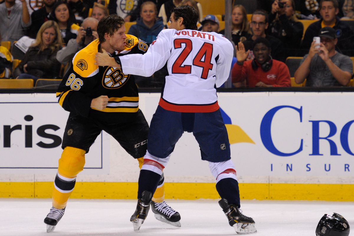 Kevan Miller engages Aaron Volpatti, AFTER each doffed the other's helmet...