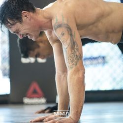 Darren Till does a push-up at UFC 228 workout.