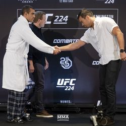Vitor Belfort and Lyoto Machida shake hands at UFC 224 media day Thursday in Rio de Janeiro.