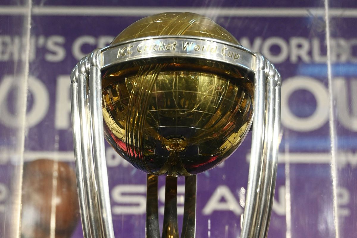 Close up of the ICC Men’s Cricket World Cup trophy. It’s a large ball, resting upon a center three pronged support with three outside supports around the edges
