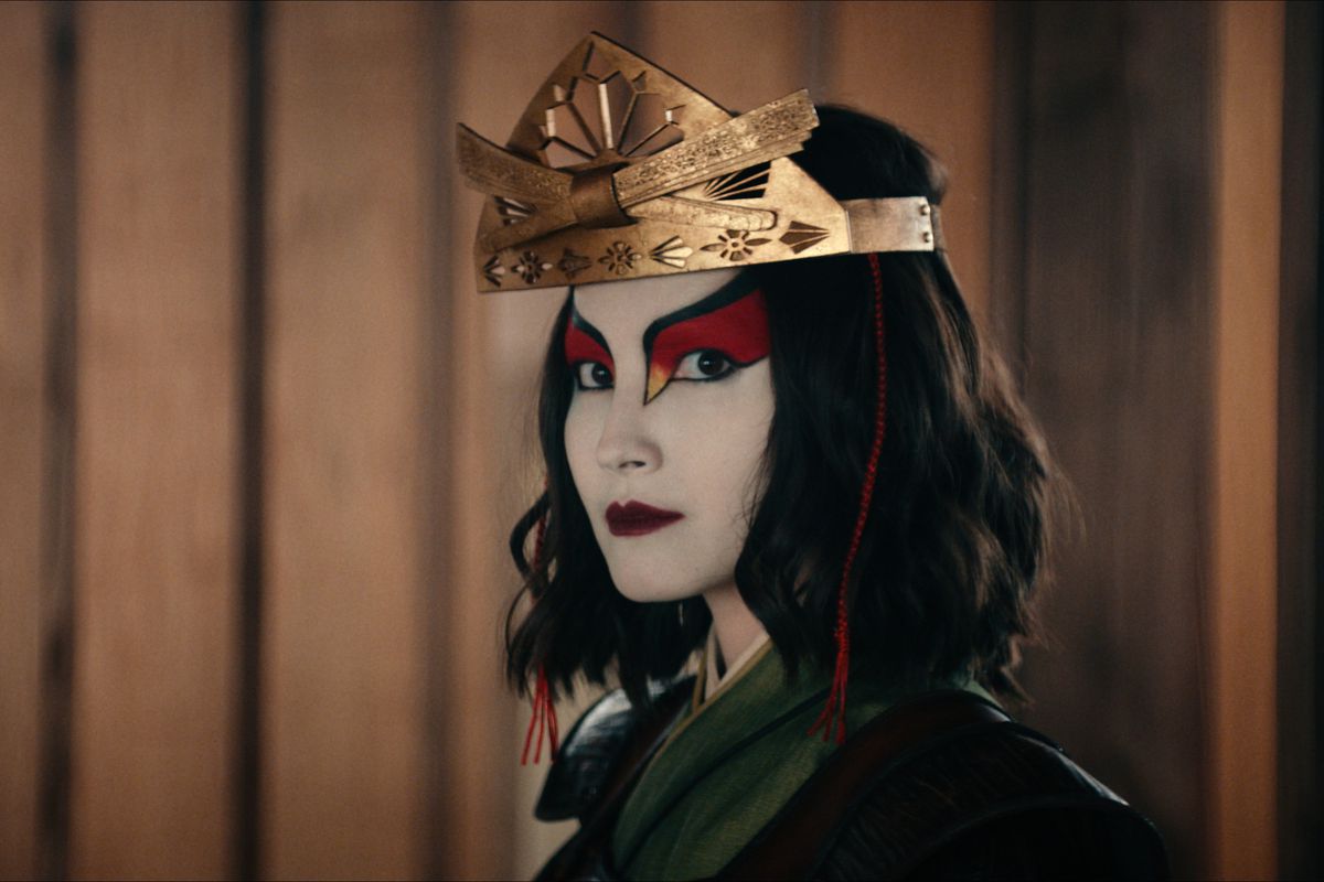 Maria Zhang as Suki in close-up in Netflix’s live-action Avatar series. Her face is painted in red, white, and black.
