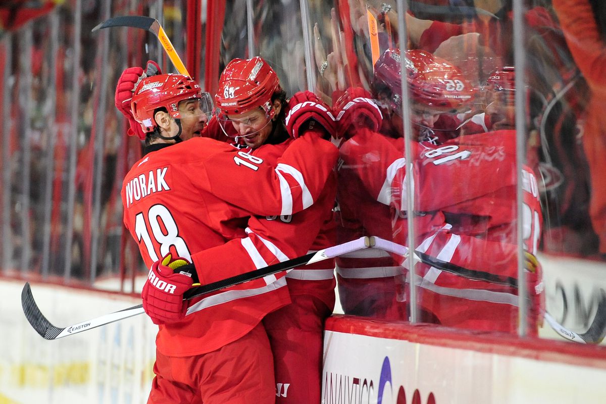 Radek Dvorak congratulates Ron Hainsey on his game-tying goal Tuesday at PNC Arena. It was Hainsey’s first goal since his days as an Atlanta Thrasher.