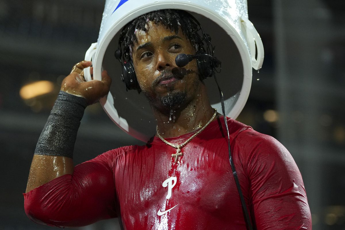 Jean Segura #2 of the Philadelphia Phillies looks on after having water poured on him after the game against the Miami Marlins at Citizens Bank Park on September 6, 2022 in Philadelphia, Pennsylvania. The Phillies defeated the Marlins 3-2.
