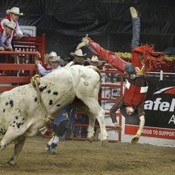 Jace Hucthison of Malta, Idaho, is bucked off a bull as LDS Church President Thomas S. Monson, far right, watches during the Days of '47 rodeo in West Valley City on Monday, July 18, 2011.