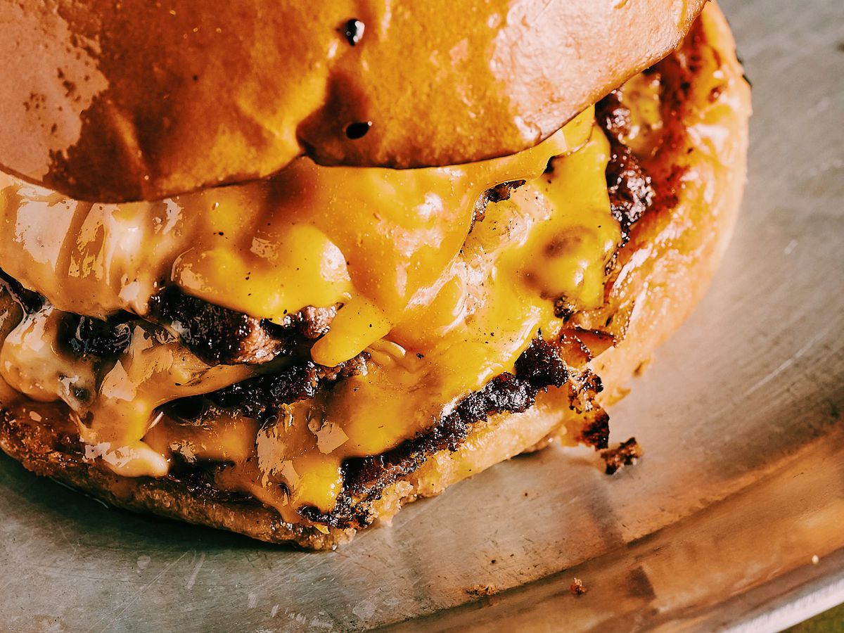A close-up view of a cheeseburger.