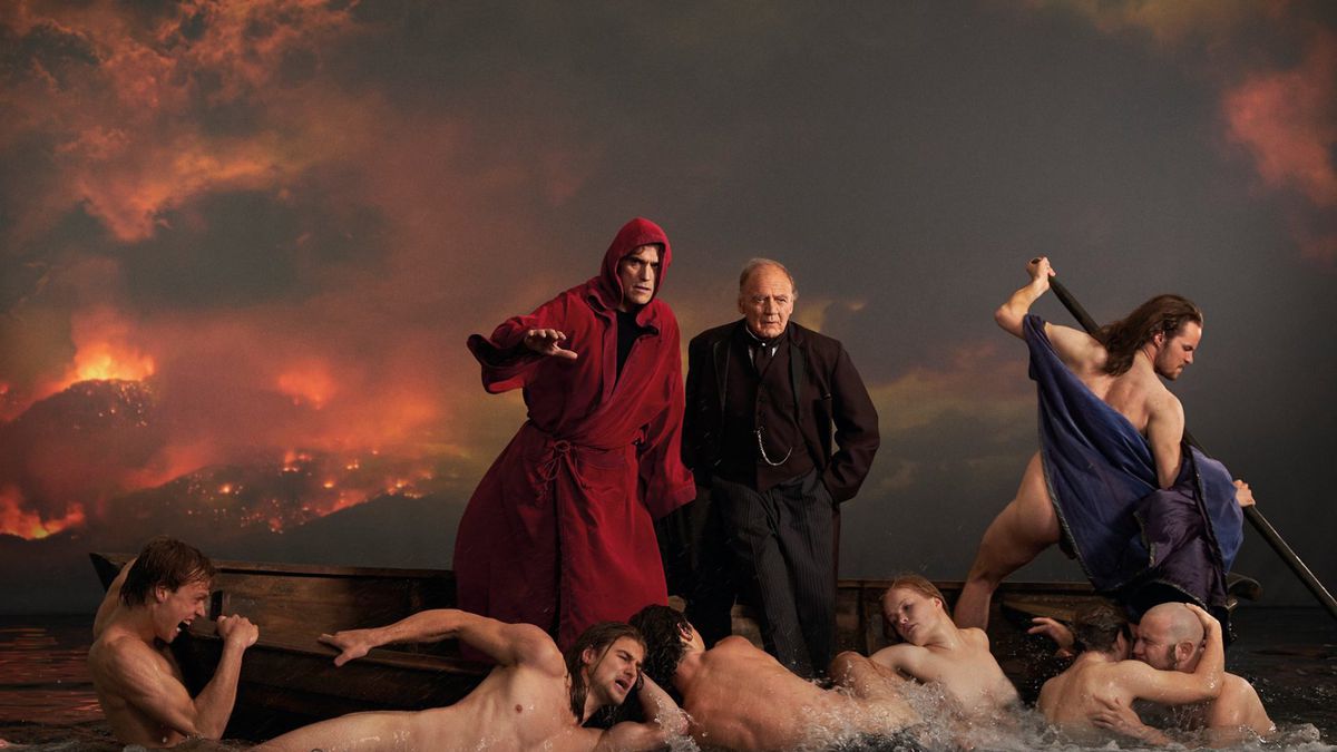 Matt Dillon, in a blood-red hooded robe, and Bruno Ganz, in a black suit, stand atop a boat as naked figures flail in the water below them, in a fantasy sequence mirroring classical Renaissance paintings.