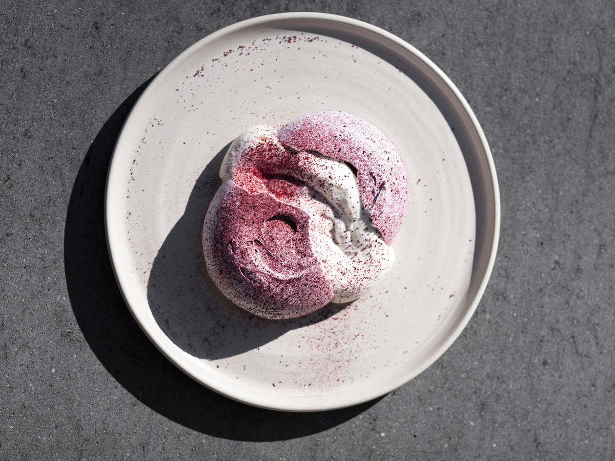 A top-down image of a white plate with the hibiscus meringue from Damian.