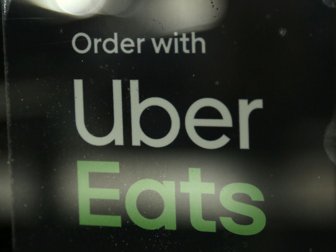A restaurant advertises Uber Eats in the Coconut Grove neighborhood in Miami in November 2019. | Lynne Sladky/AP