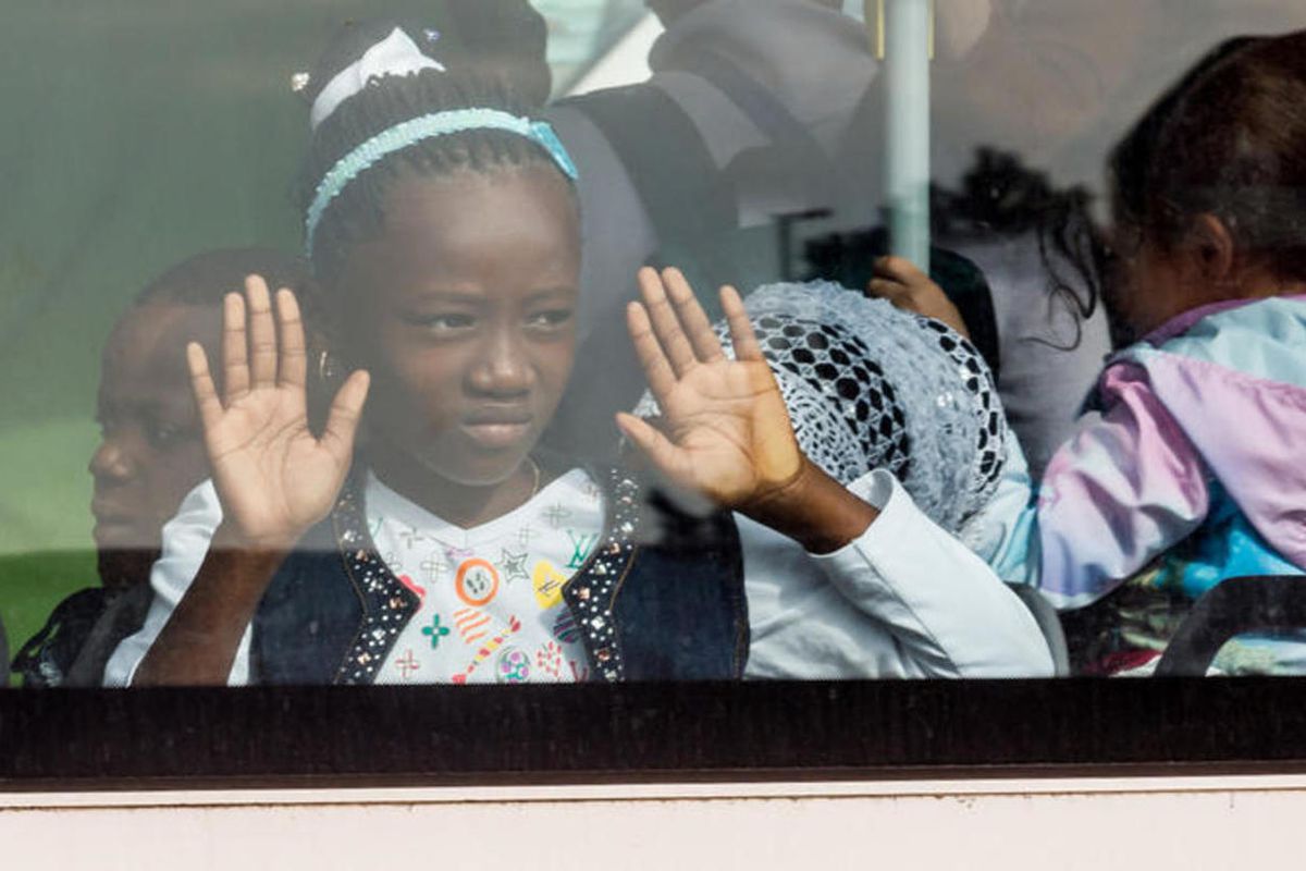 A young girl looks out of the window of a bus after being evacuated from Brussels airport, after explosions rocked the facility in Brussels, Belgium, Tuesday March 22, 2016. The terror attacks that rocked Brussels on Tuesday morning — injuring four LDS Ch