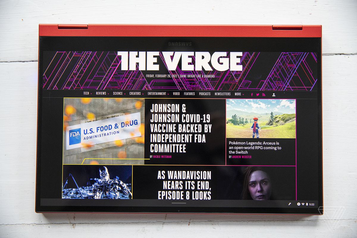 The Samsung Galaxy Chromebook 2 in tent mode with the screen facing the camera, displaying The Verge homepage.