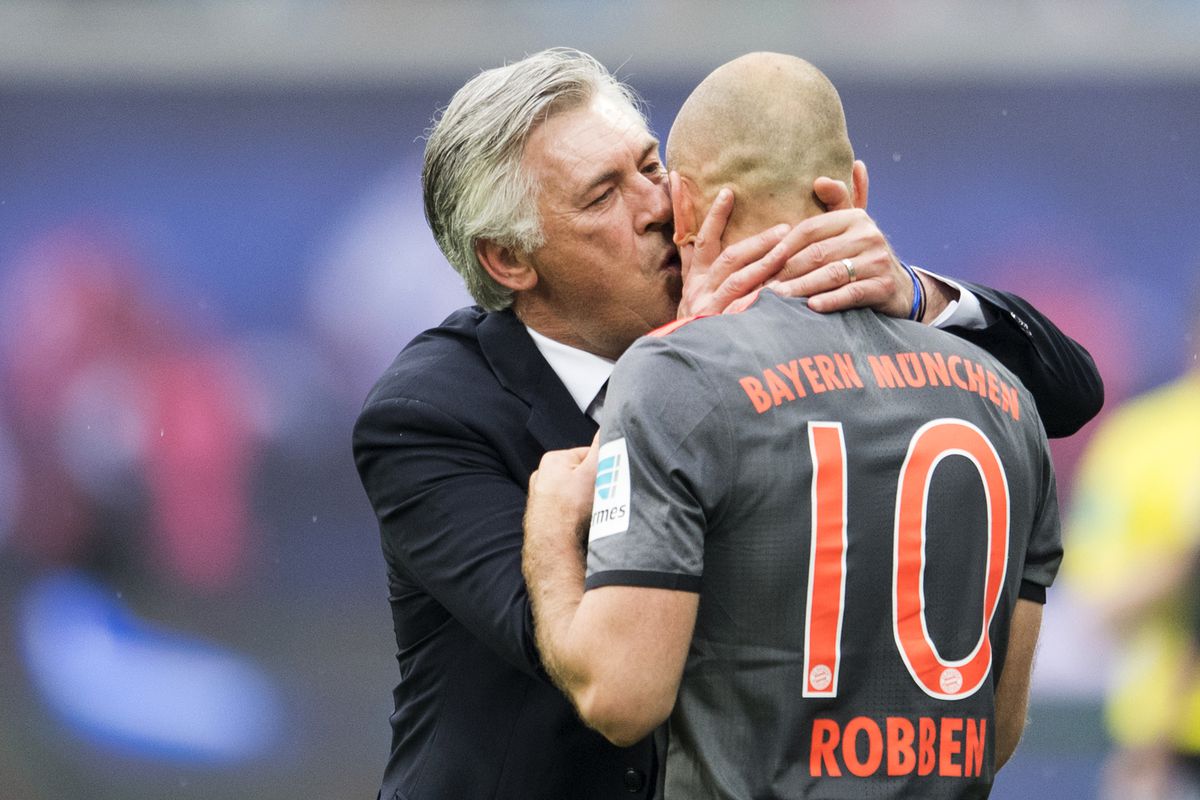 Bayern Munich's Italian head coach Carlo Ancelotti (L) kisses Bayern Munich's Dutch midfielder Arjen Robben as he scored the 4-5 during extra time of the German first division Bundesliga football match between RB Leipzig and FC Bayern Munich on May 13, 2017 in Leipzig, eastern Germany.
