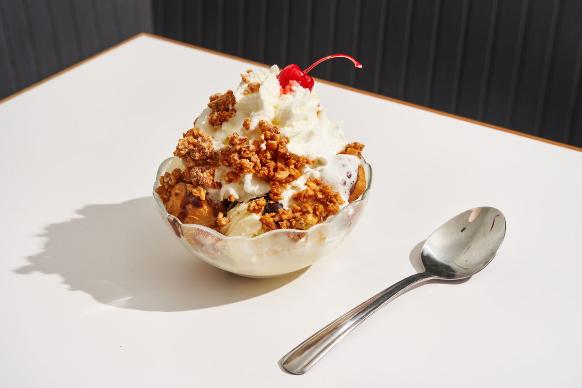 An ice cream sundae with fried milk cubes, Ovaltine fudge, and buttered peanuts.