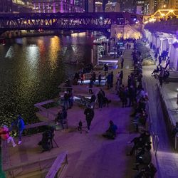 Hundreds gather around in front of the Merchandise Mart on Chicago’s Riverwalk to watch the kick off “Art on the Mart” with a special ‘Nutcracker’ themed presentation from Joffrey Ballet, Thursday, Nov. 13, 2020. 