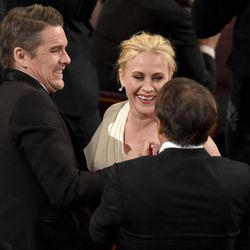 Ethan Hawke, left, and Richard Linklater, right, congratulate Patricia Arquette after she wins the award for best actress in a supporting role for “Boyhood” at the Oscars on Sunday, Feb. 22, 2015, at the Dolby Theatre in Los Angeles. 